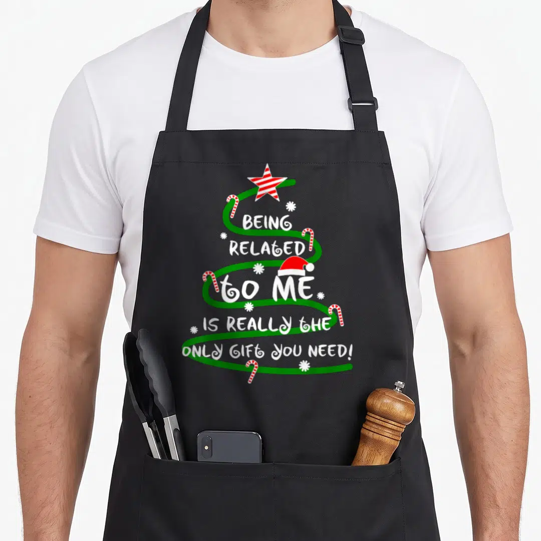 Related i love star apron - Green spiral Christmas tree with red white star Santa hat candy canes and white text — shown on a black cotton canvas apron against a white background