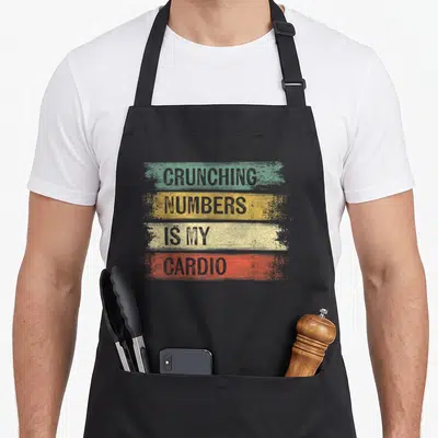 Crunching accountant apron - Stacked text CRUNCHING NUMBERS IS MY CARDIO on teal, yellow, beige, and orange distressed — shown on a black cotton canvas apron against a white background
