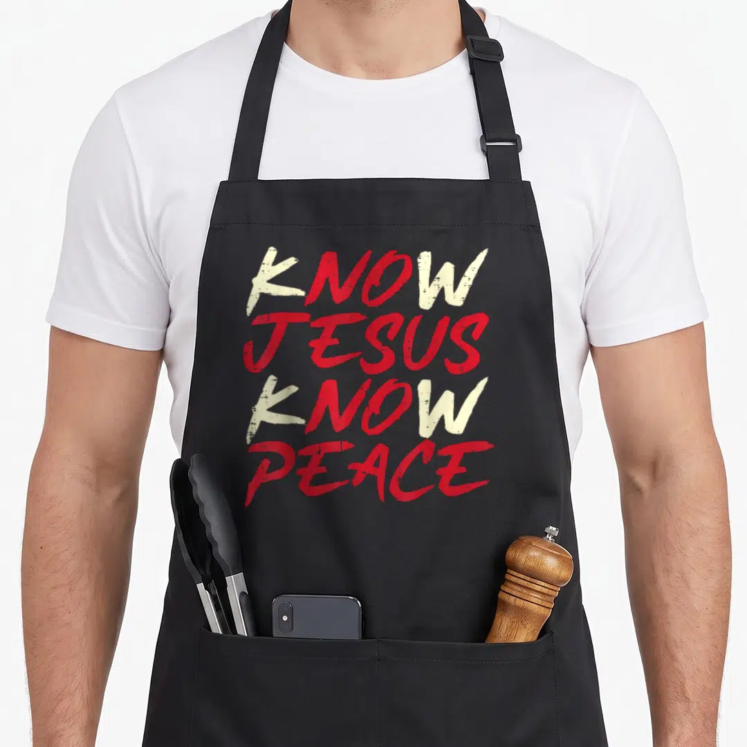 Peace christian aprons - Stacked red and white distressed text reading KNOW JESUS KNOW PEACE — shown on a black cotton canvas apron against a white background