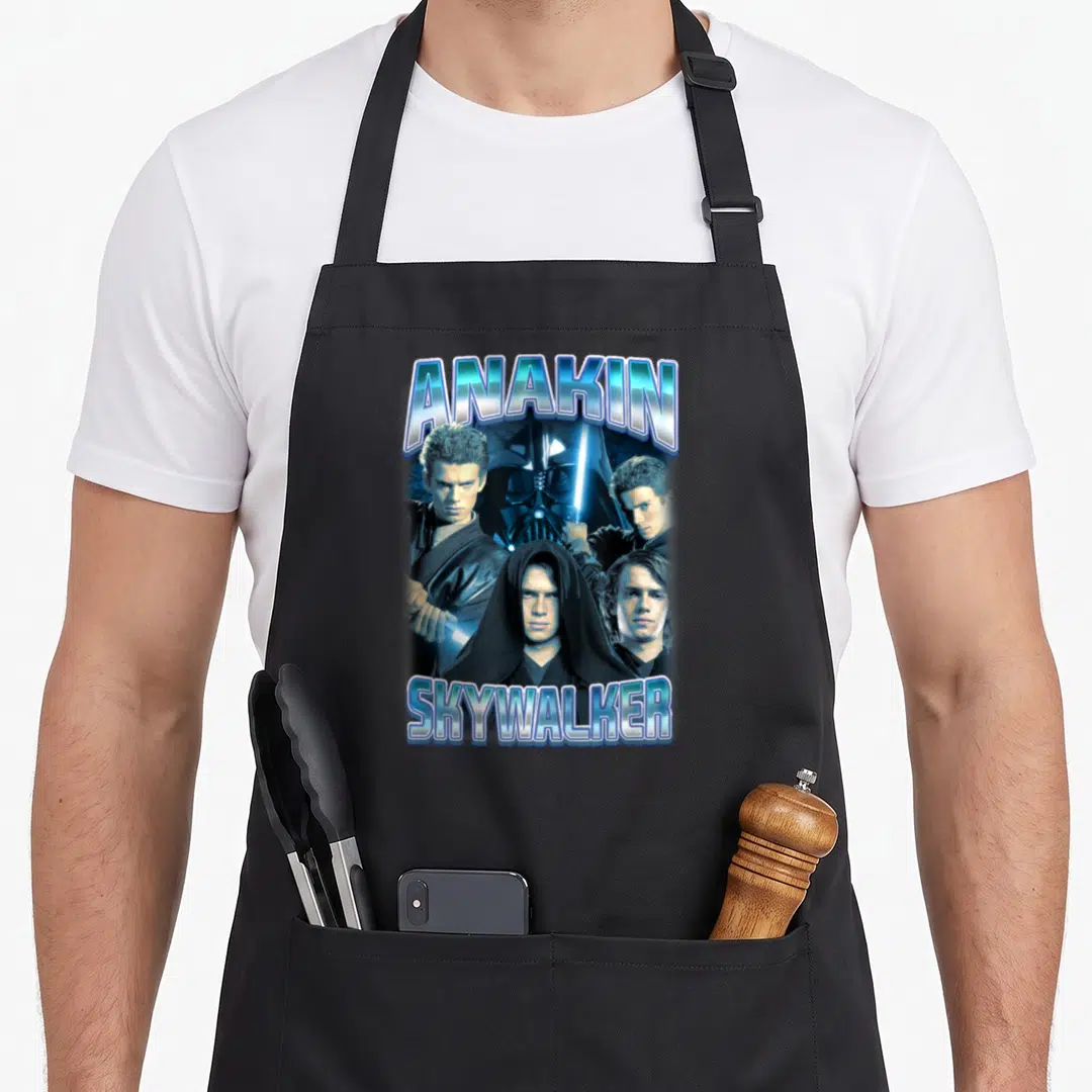 Anakin photo collage apron - Anakin Skywalker photo collage with Vader mask and blue lightsabers in blue black silver — shown on a black cotton canvas apron against a white background
