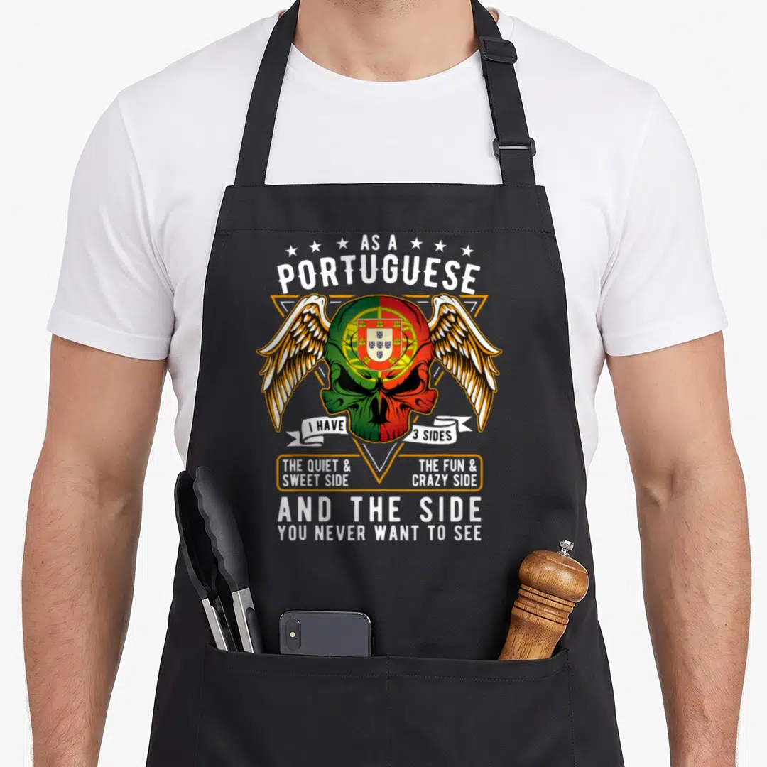 Portugal portuguese apron - Winged skull colored in green and red with gold triangle and white text describing — shown on a black cotton canvas apron against a white background