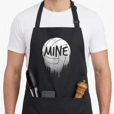 Mine training apron - White volleyball with grey MINE text and paint drip effect — shown on a black cotton canvas apron against a white background