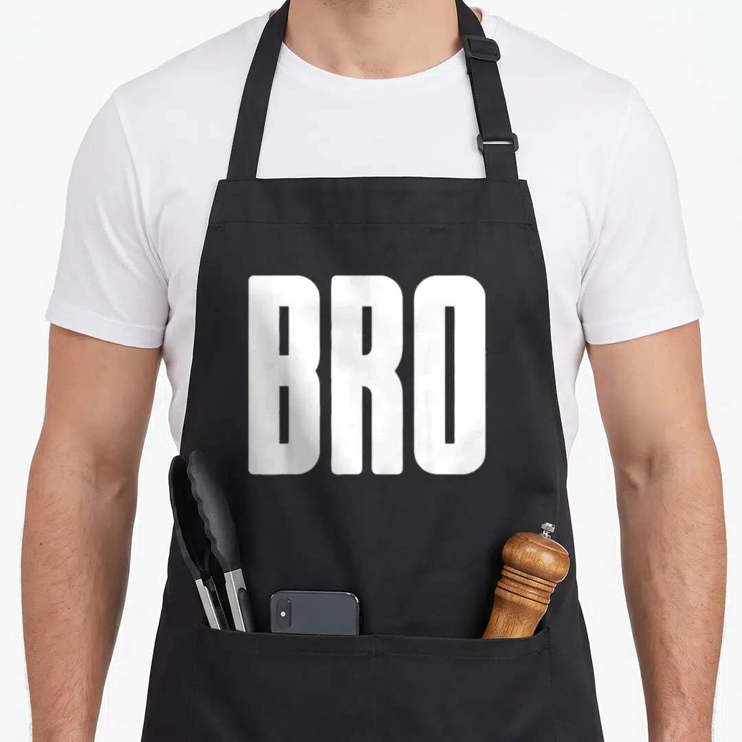 Bro friends apron - White BRO text on black background, bold typography — shown on a black cotton canvas apron against a white background