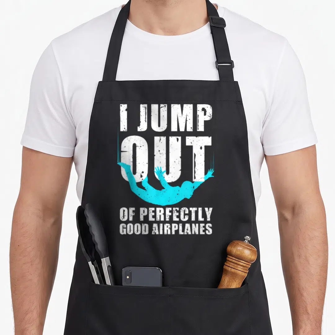 Skydiver freediving apron - I JUMP OUT OF PERFECTLY GOOD AIRPLANES text with cyan falling figure — shown on a black cotton canvas apron against a white background
