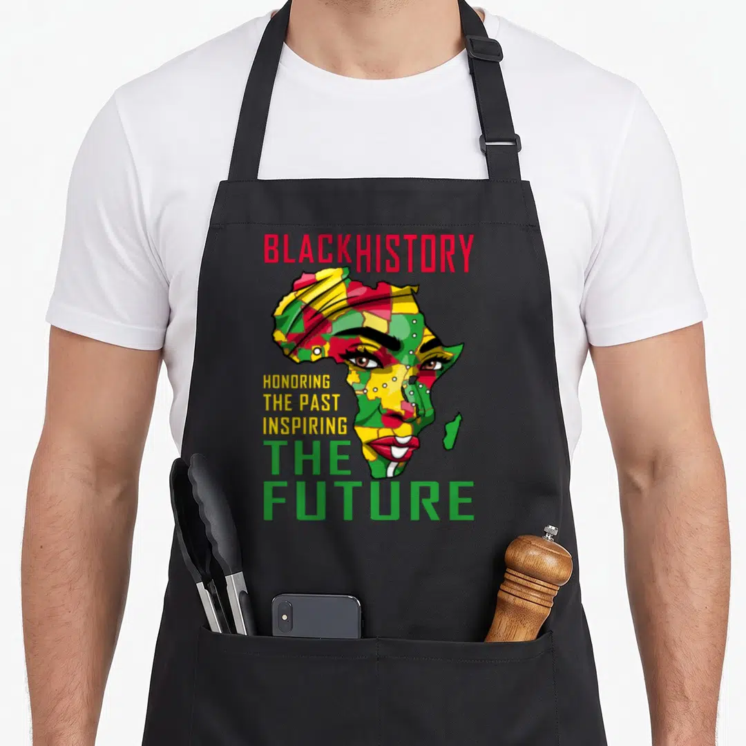 Past future it apron - Woman's face shaped like Africa map with red yellow green text — shown on a black cotton canvas apron against a white background