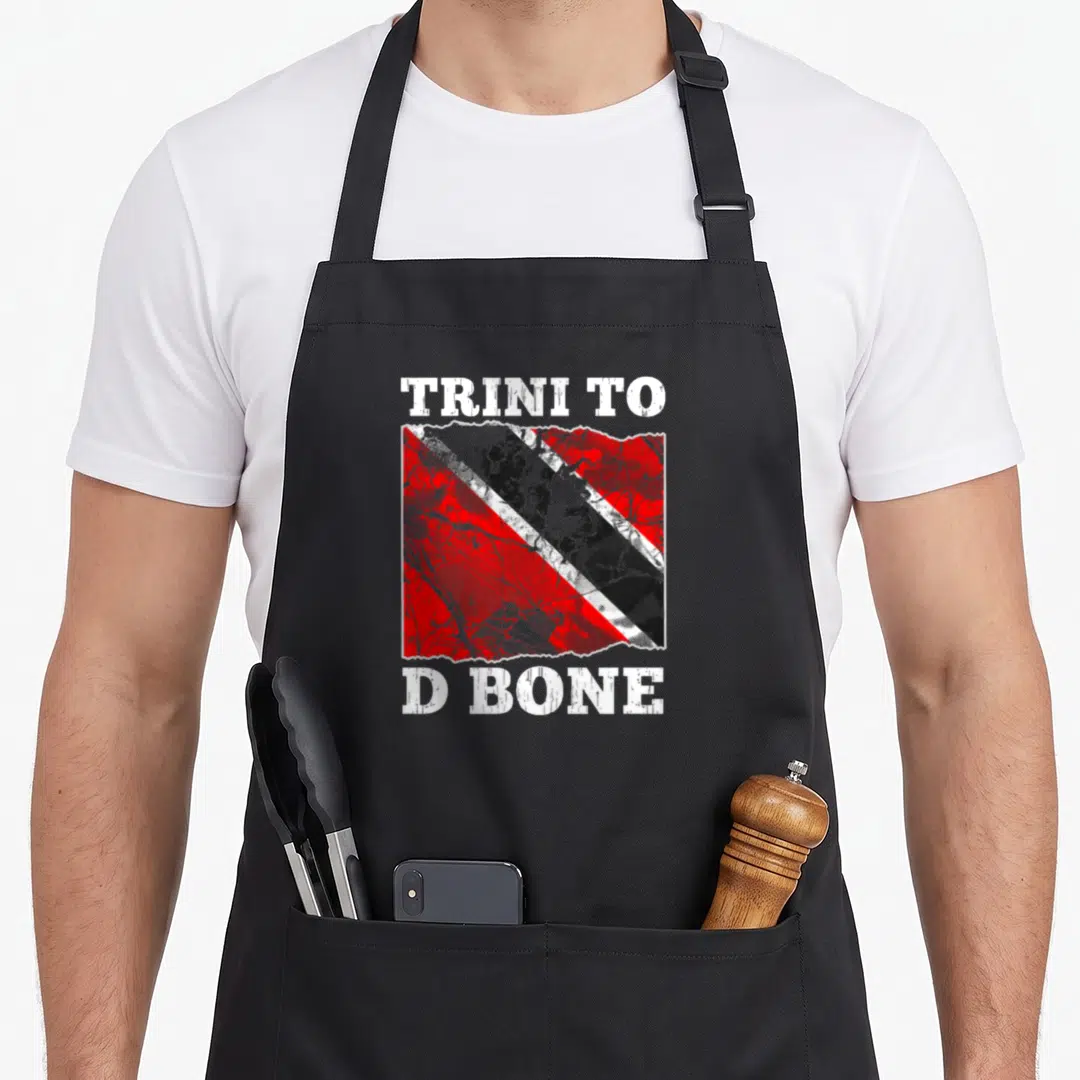 Flag trinidad and tobago apron - Distressed red white black flag with TRINI TO D BONE text above and below — shown on a black cotton canvas apron against a white background