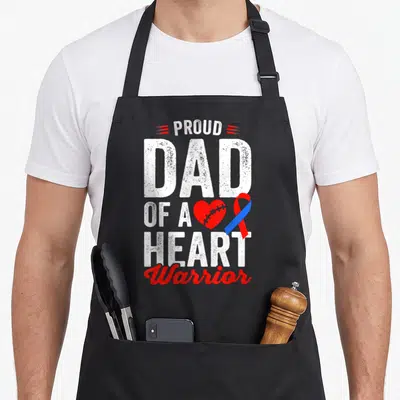 Warrior chd congenital heart defect apron - PROUD DAD OF A HEART Warrior text with stitched red heart and blue red — shown on a black cotton canvas apron against a white background