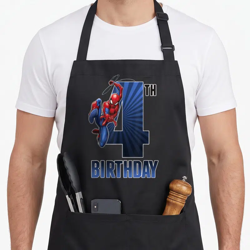 Swinging birthday apron - Spider-Man leaping over blue number 4 with TH BIRTHDAY text — shown on a black cotton canvas apron against a white background