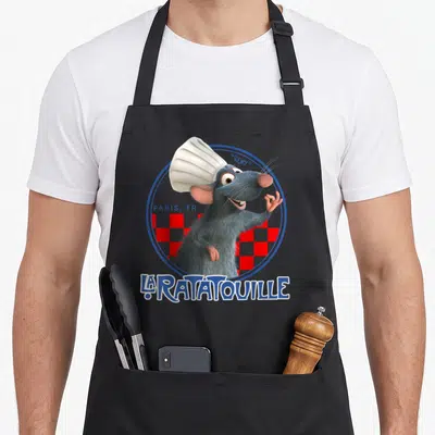 Hat remy ratatouille apron - Grey rat chef in white hat inside blue circle with red checkered background and Paris text — shown on a black cotton canvas apron against a white background