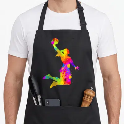Cute player basketball apron - Jumping basketball player silhouette filled with multicolored paint splatters in red — shown on a black cotton canvas apron against a white background