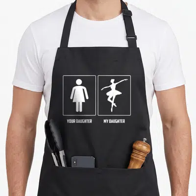 Dancing mom daughter apron - White square frames with generic icon and ballerina silhouette labeled YOUR DAUGHTER MY — shown on a black cotton canvas apron against a white background