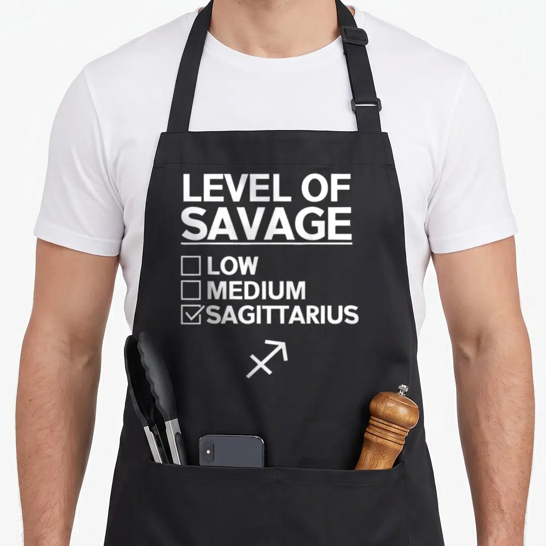Vintage sagittarius zodiac aprons - White Level of Savage checklist with Sagittarius checked and arrow symbol below — shown on a black cotton canvas apron against a white background