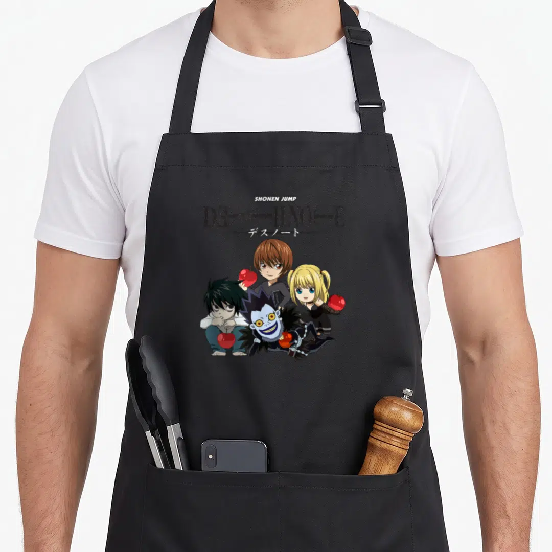 Chibi apple apron - Four chibi characters holding three red apples under stacked SHONEN JUMP and DEATH NOTE text — shown on a black cotton canvas apron against a white background
