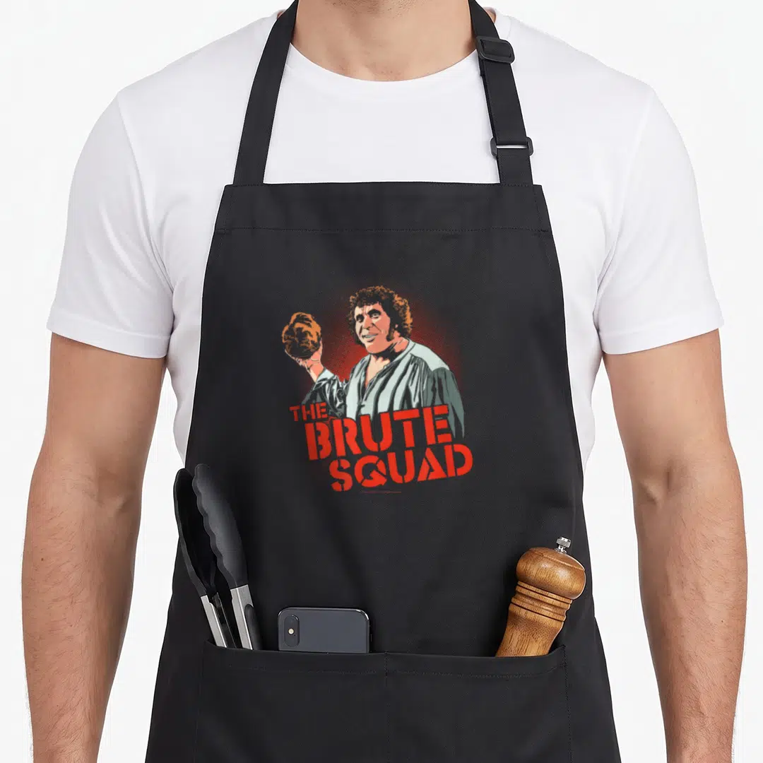 Bride andre princess apron - Cartoon man holding rock above red stacked text reading The Brute Squad — shown on a black cotton canvas apron against a white background