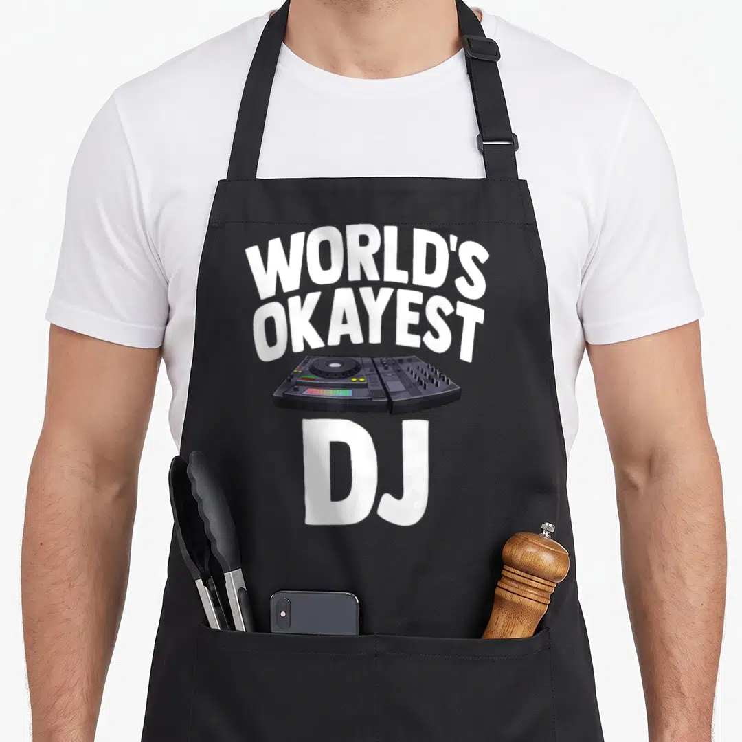 Okayest turntables and aprons - White text reading WORLD'S OKAYEST DJ over a black mixer controller illustration — shown on a black cotton canvas apron against a white background