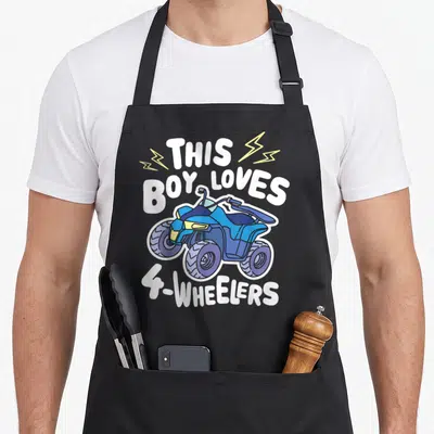 Quad atv apron - Blue cartoon ATV with THIS BOY LOVES 4-WHEELERS text and yellow lightning bolts — shown on a black cotton canvas apron against a white background