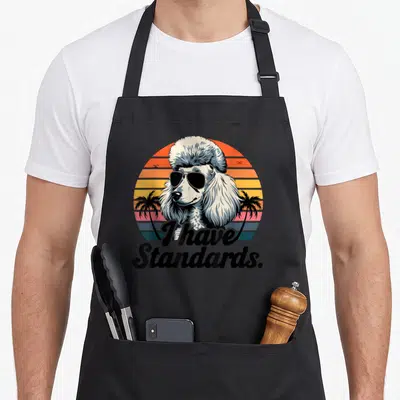 Poodle standard size of apron for kids - Retro poodle sunglasses striped sun I have Standards text — shown on a black cotton canvas apron against a white background