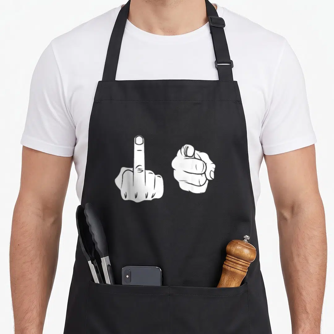 Middle fun hand apron - Two white line-art hands, one flipping the bird and one pointing forward — shown on a black cotton canvas apron against a white background