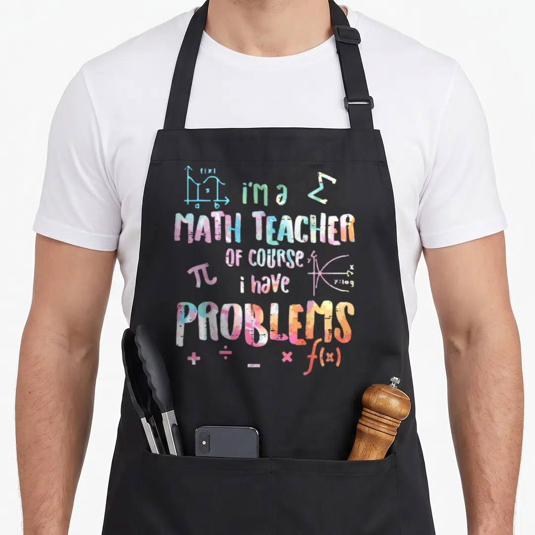 Course teacher apron - Watercolor math teacher text with pi, integrals, and operators in pink blue yellow green orange — shown on a black cotton canvas apron against a white background
