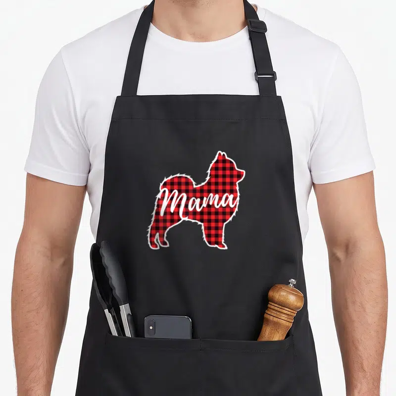 Pomeranian red plaid apron - Red black and white plaid Pomeranian silhouette with Mama written in white script — shown on a black cotton canvas apron against a white background