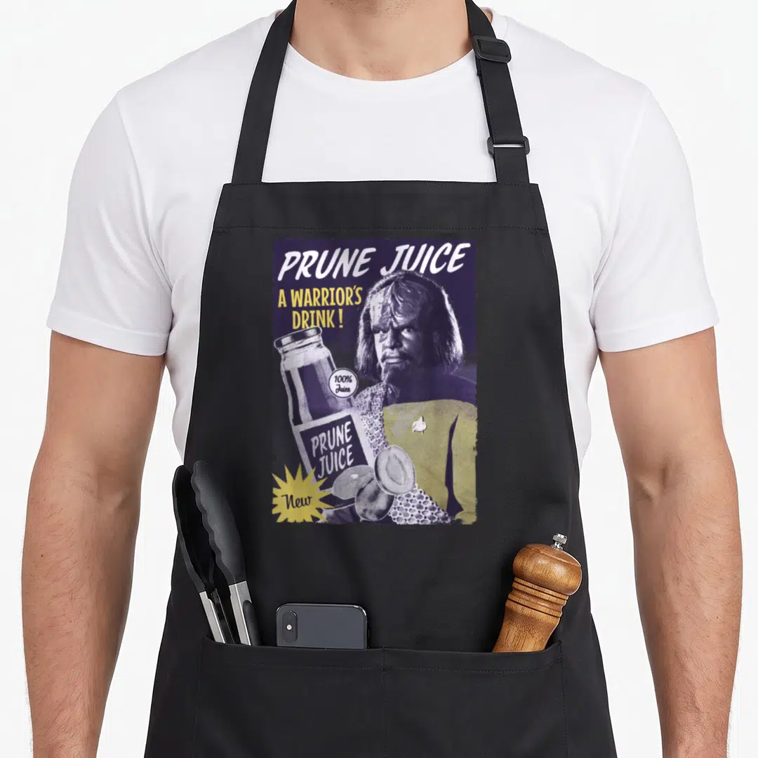 Generation juice apron - Retro purple poster of a Klingon warrior holding a prune juice bottle with prunes at the bottom — shown on a black cotton canvas apron against a white background
