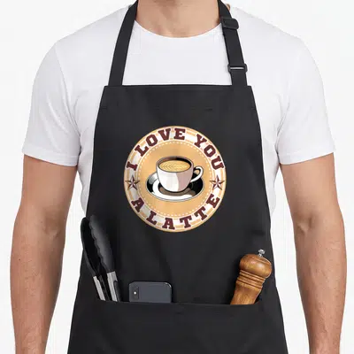 Cappuccino coffee apron - Retro coffee cup inside tan circle with I Love You A Latte text and stars — shown on a black cotton canvas apron against a white background