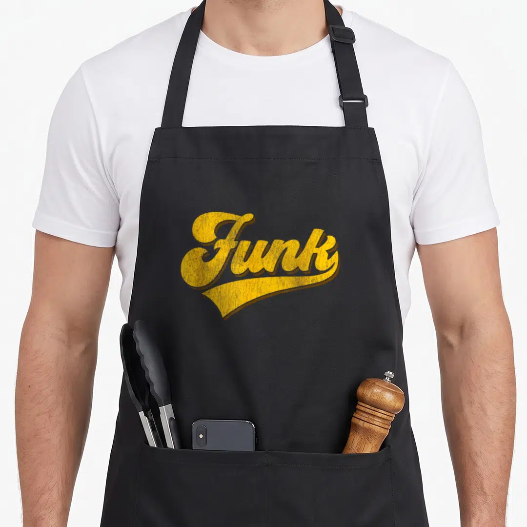 Soul 80s apron - Yellow stylized Funk text with a decorative swoosh underline — shown on a black cotton canvas apron against a white background