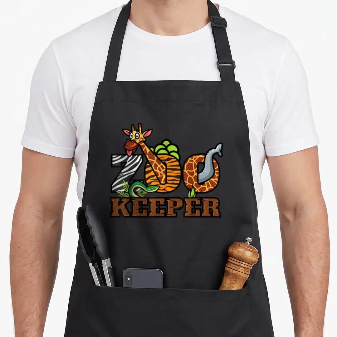 Zoo keeper animal apron - Cartoon giraffe snake and elephant trunk forming ZOO KEEPER text in brown yellow green grey — shown on a black cotton canvas apron against a white background