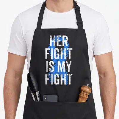 Colon crab mom apron - Her Fight Is My Fight white text over blue brush stroke pattern — shown on a black cotton canvas apron against a white background