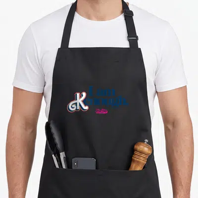 Funny i am kenough apron - Stacked text I am Kenough in blue white pink with small logo — shown on a black cotton canvas apron against a white background