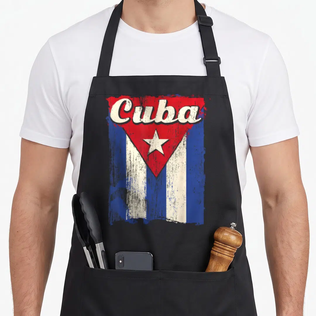 Cuba flag hispanic aprons - Distressed Cuban flag with script Cuba text and red white blue colors — shown on a black cotton canvas apron against a white background