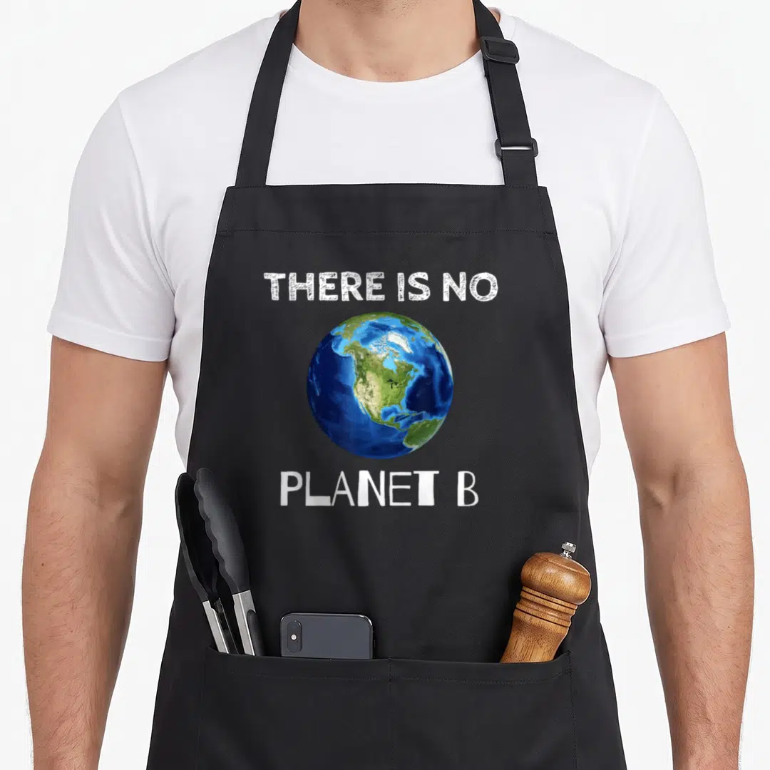 Planet ecologist apron - THERE IS NO PLANET B text framing a blue and green Earth globe — shown on a black cotton canvas apron against a white background