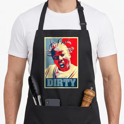 Ard ba apron - Stylized man portrait with red and blue split background and block text DIRTY at bottom — shown on a black cotton canvas apron against a white background
