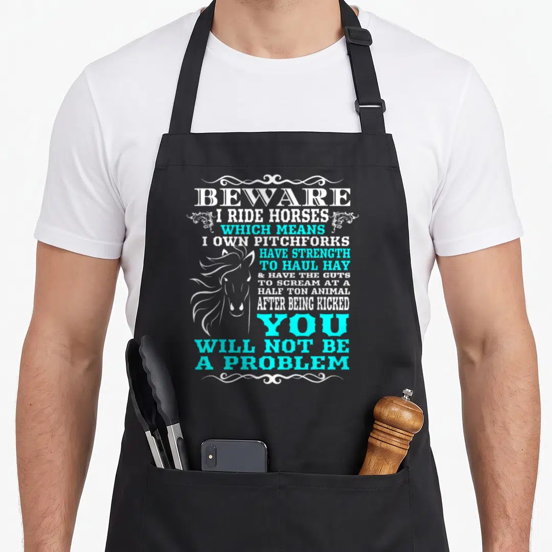Beware horse apron - White and cyan stacked text reading beware I ride horses with horse head silhouette — shown on a black cotton canvas apron against a white background