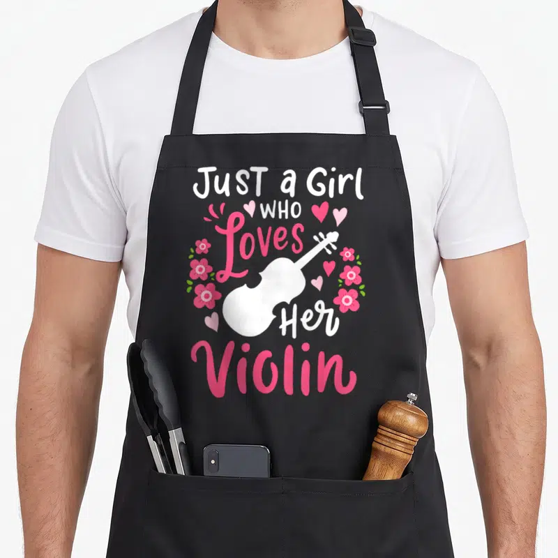 Funny violinist violin apron - Just a Girl Who Loves Her Violin text with pink flowers and hearts — shown on a black cotton canvas apron against a white background