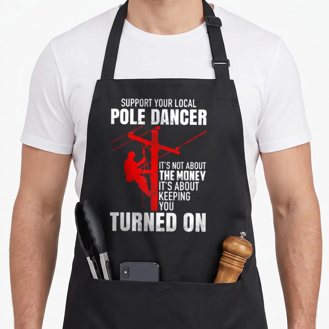 Support pole apron - Red lineman silhouette climbing a utility pole with white distressed text — shown on a black cotton canvas apron against a white background