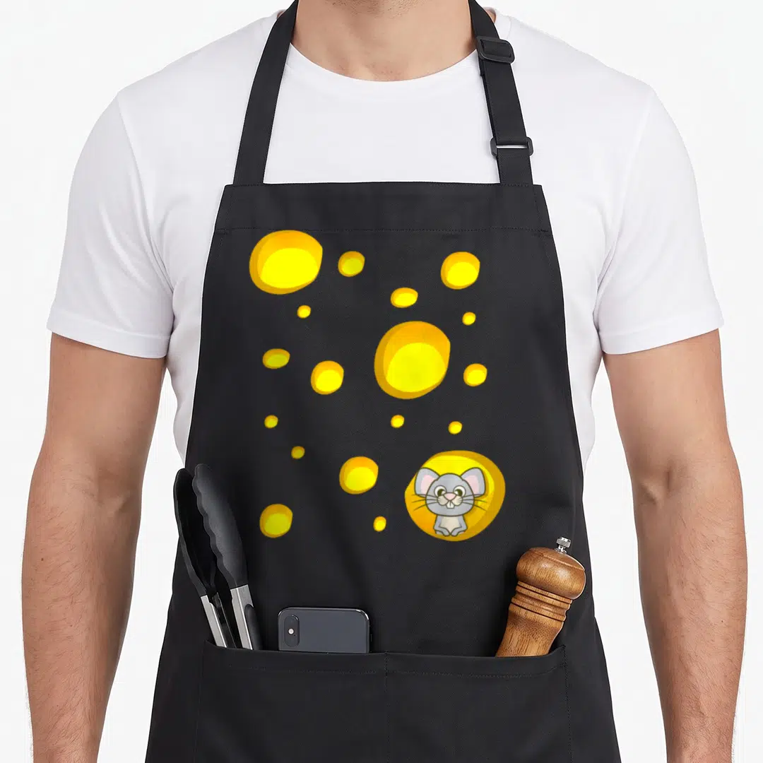 Costume swiss apron - Cartoon grey mouse sitting in yellow cheese hole surrounded by scattered yellow circles on grey — shown on a black cotton canvas apron against a white background