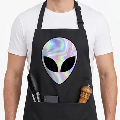 Alien colorful aprons - Holographic alien head in blue pink purple black with two front pockets — shown on a black cotton canvas apron against a white background