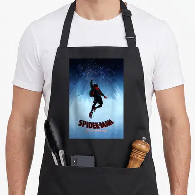 Spiderverse novelty apron - Spider-Man leaping upward against inverted blue cityscape with red and black title text — shown on a black cotton canvas apron against a white background