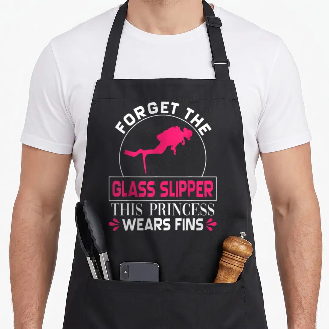 Scuba princess apron - Pink scuba diver silhouette with text forget glass slipper wears fins in white and pink — shown on a black cotton canvas apron against a white background