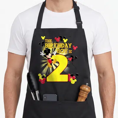 2nd best friend aprons - Mickey Mouse leaning on yellow number 2 with red black and white balloons — shown on a black cotton canvas apron against a white background