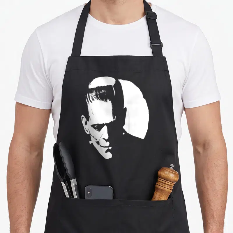 Youth halloween apron - White silhouette of a man's head and shoulders on grey background — shown on a black cotton canvas apron against a white background