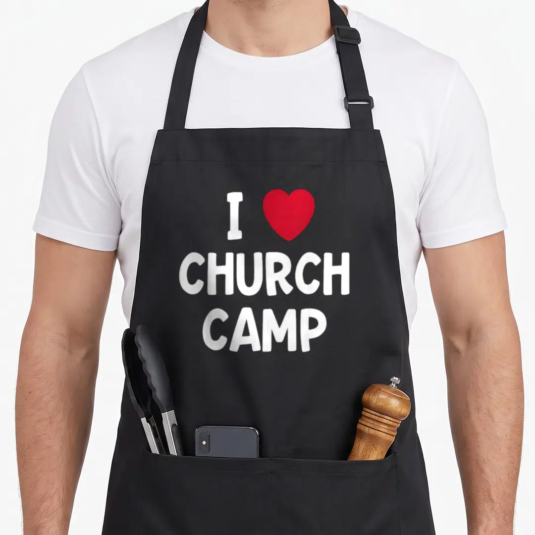 Camp christian apron - White letter I red heart shape and stacked CHURCH CAMP text on dark background — shown on a black cotton canvas apron against a white background