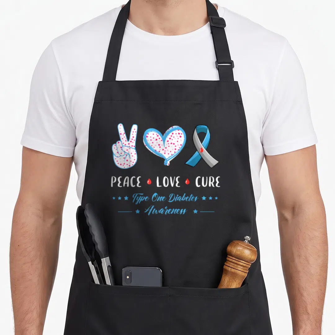 Peace diabete awareness apron - Peace sign heart ribbon with PEACE LOVE CURE text and red drops in blue white red grey — shown on a black cotton canvas apron against a white background