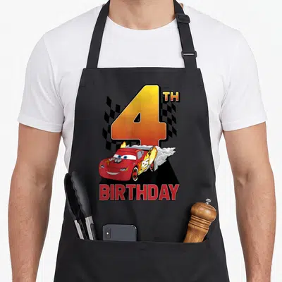 4th car apron - Large number 4 with red race car, checkered flag, and BIRTHDAY text in cartoon style — shown on a black cotton canvas apron against a white background