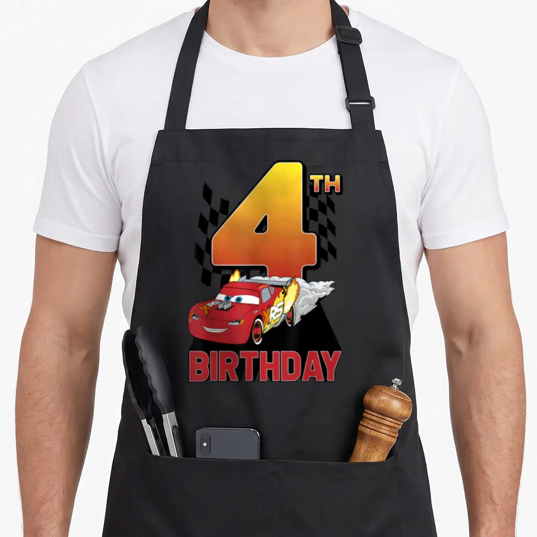 4th car apron - Large number 4 with red race car, checkered flag, and BIRTHDAY text in cartoon style — shown on a black cotton canvas apron against a white background