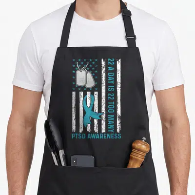 Many veterans apron - Distressed flag with dog tags, teal ribbon, and 22 A Day is 22 Too Many text — shown on a black cotton canvas apron against a white background