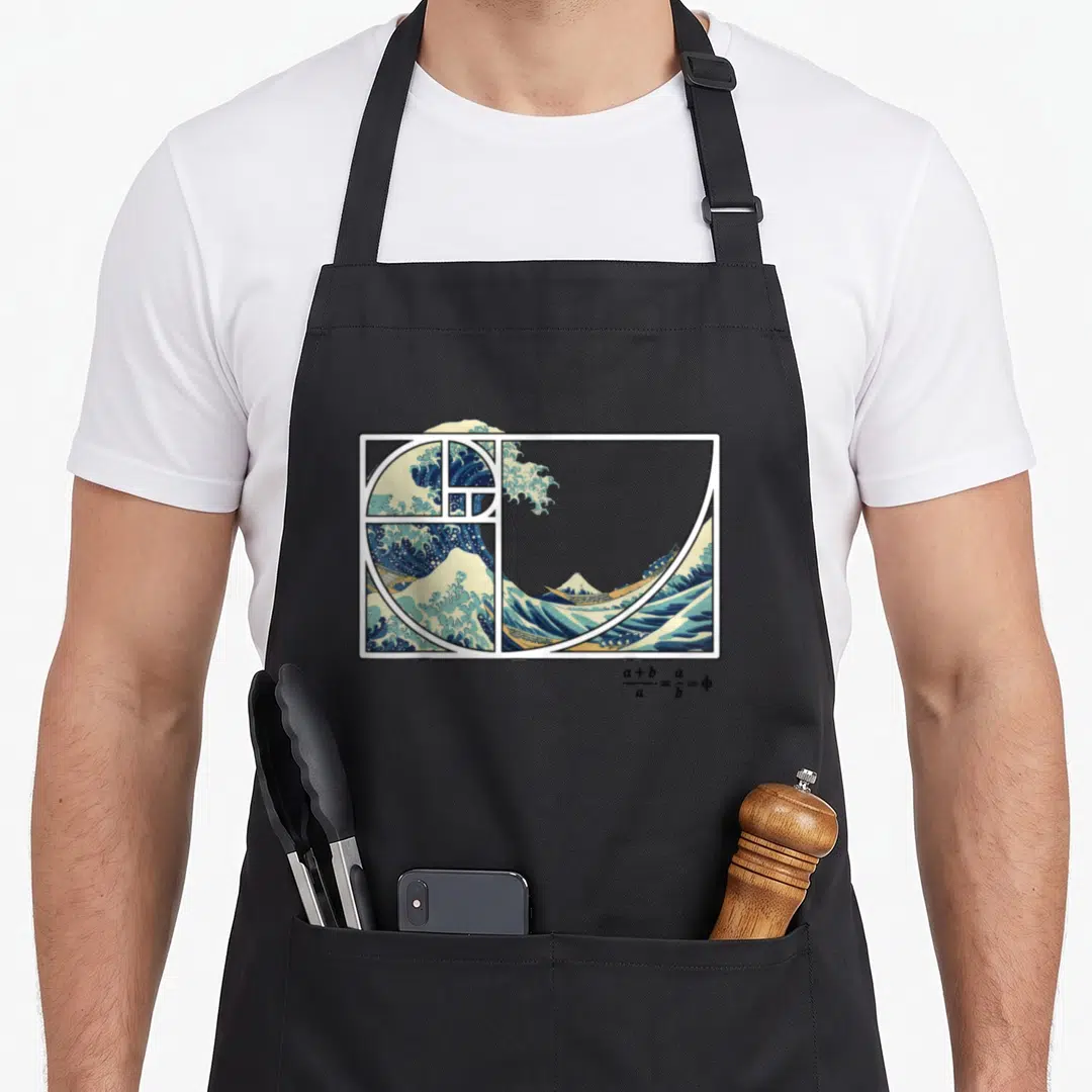 Kanagawa fibonacci apron - Great Wave off Kanagawa with golden spiral and phi formula in blue and beige — shown on a black cotton canvas apron against a white background