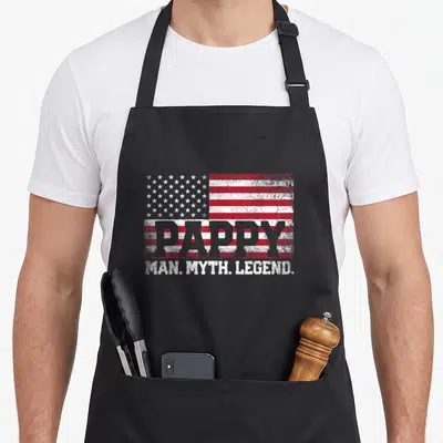 Pappy grandpa apron - Distressed USA flag with PAPPY and MAN MYTH LEGEND text — shown on a black cotton canvas apron against a white background