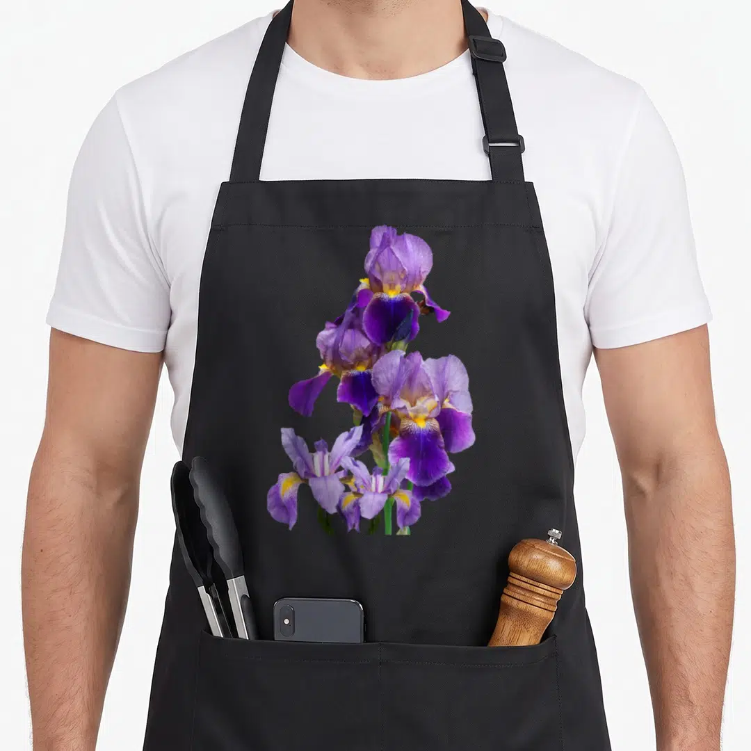 Iris gardener apron - Vertical cluster of purple iris flowers with yellow centers and green stems — shown on a black cotton canvas apron against a white background